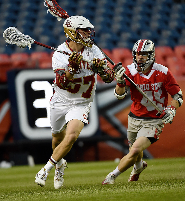 colin woolford (57) of the denver pioneers controls the ball as